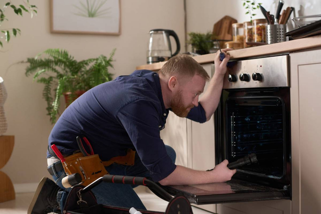 Professional mechanic examining an oven that doesn’t get hot enough